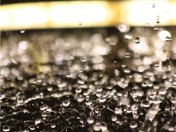 Close up photo of water droplets against dancing in the air