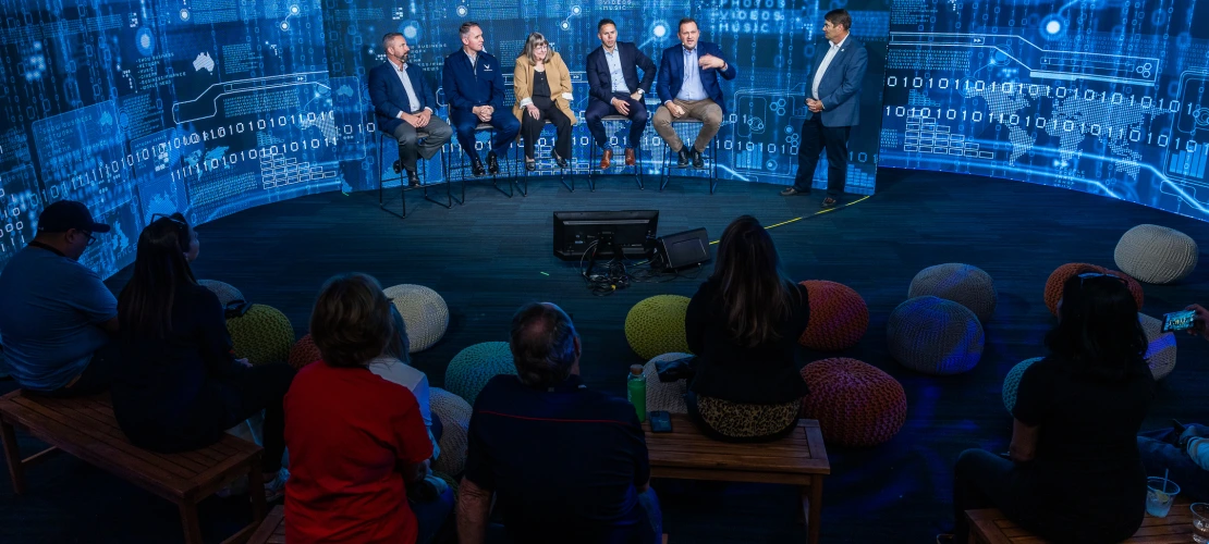 Cyber panel talking in front of a digital background