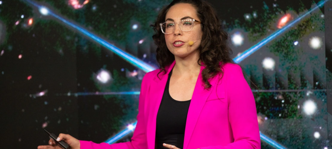Erika Hamden in front of a field of stars
