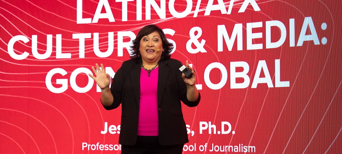 Jessica Retis in front of title slide for talk