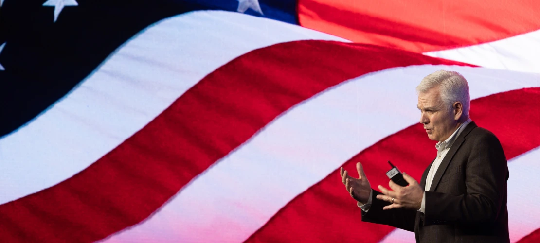 Keith Allred in front of US flag background