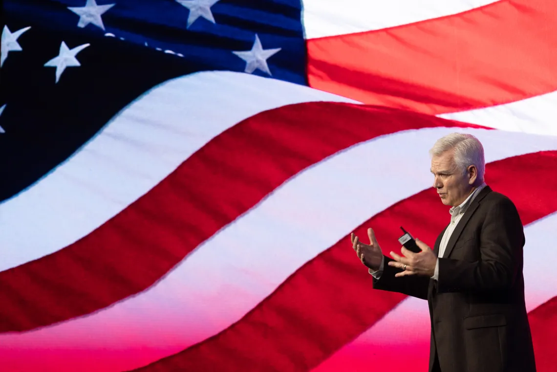 Keith Allred in front of US flag background